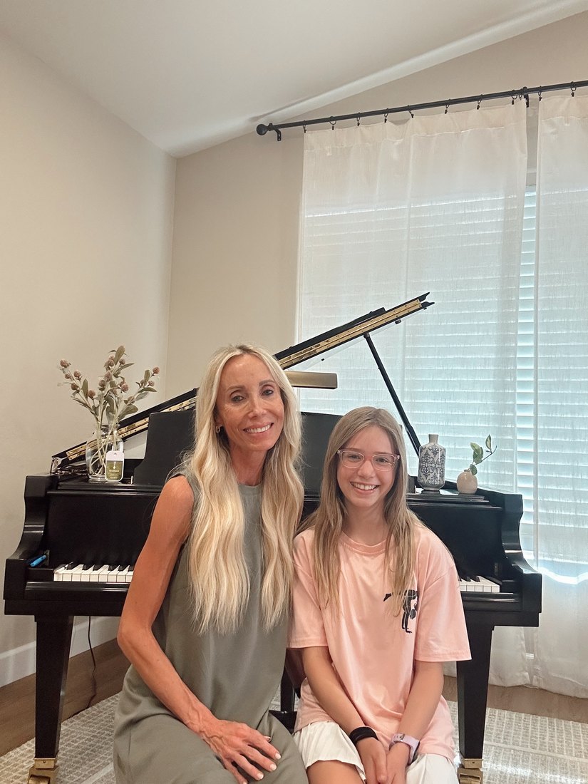 Julie Durrant with a smiling piano student at the studio